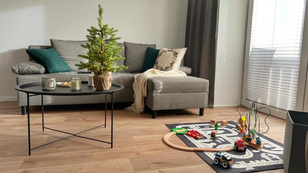 a living room with a christmas tree and a couch at Gojka Apartamenty in Piekielnik