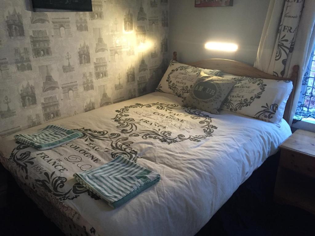 a bedroom with a bed with white sheets and pillows at Bradleys Hotel in Blackpool