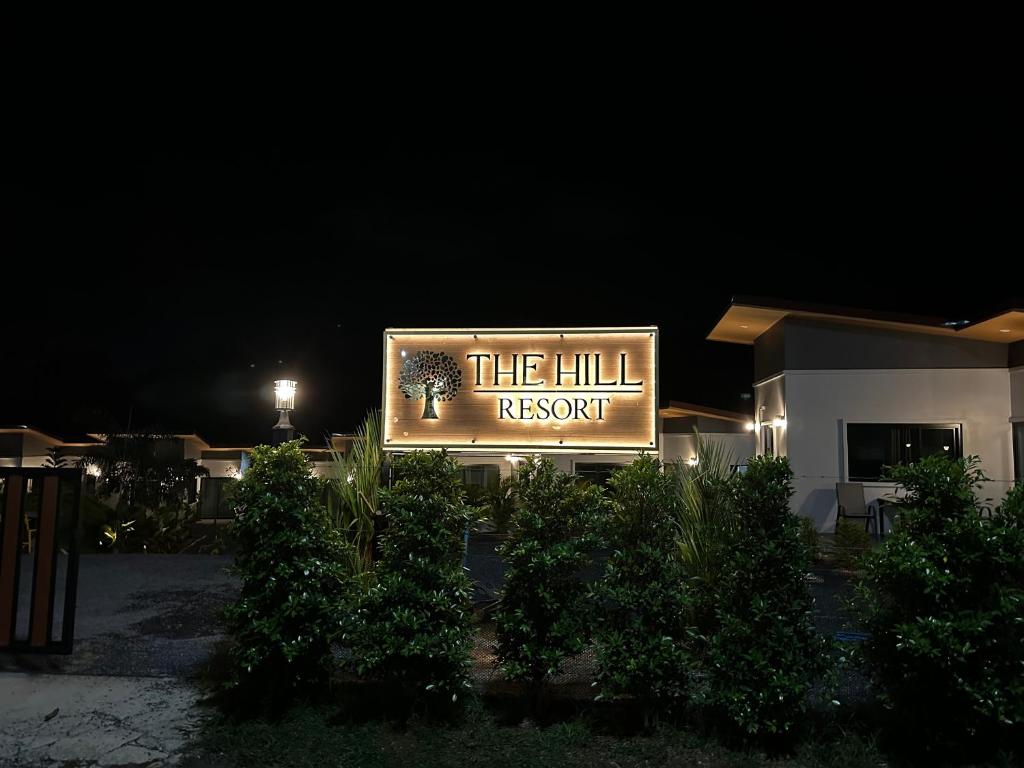 a sign for the hill resort at night at The Hill resort Thalang in Phuket Town