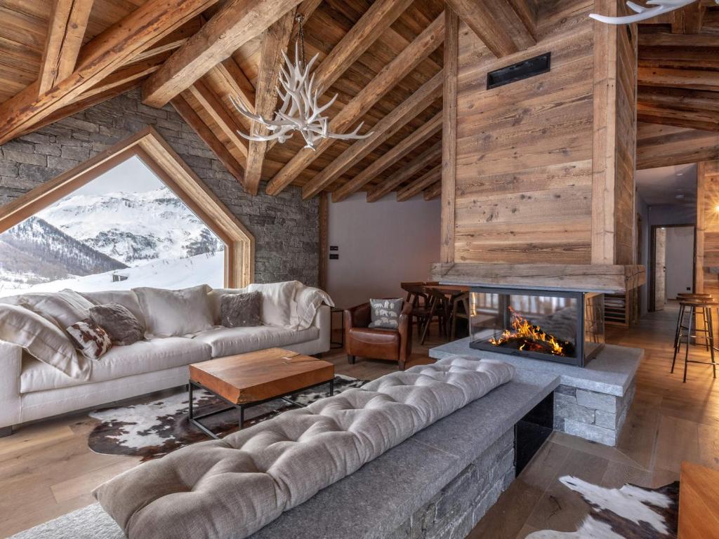 a living room with a couch and a fireplace at Chalet Val-d'Isère, 8 pièces, 12 personnes - FR-1-694-3 in Val-d'Isère