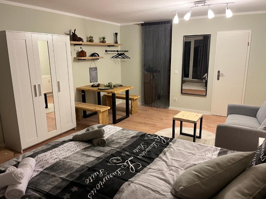 a living room with a bed and a couch at Studio an der Elbe mit Balkon, Küche und Netflix in Dresden