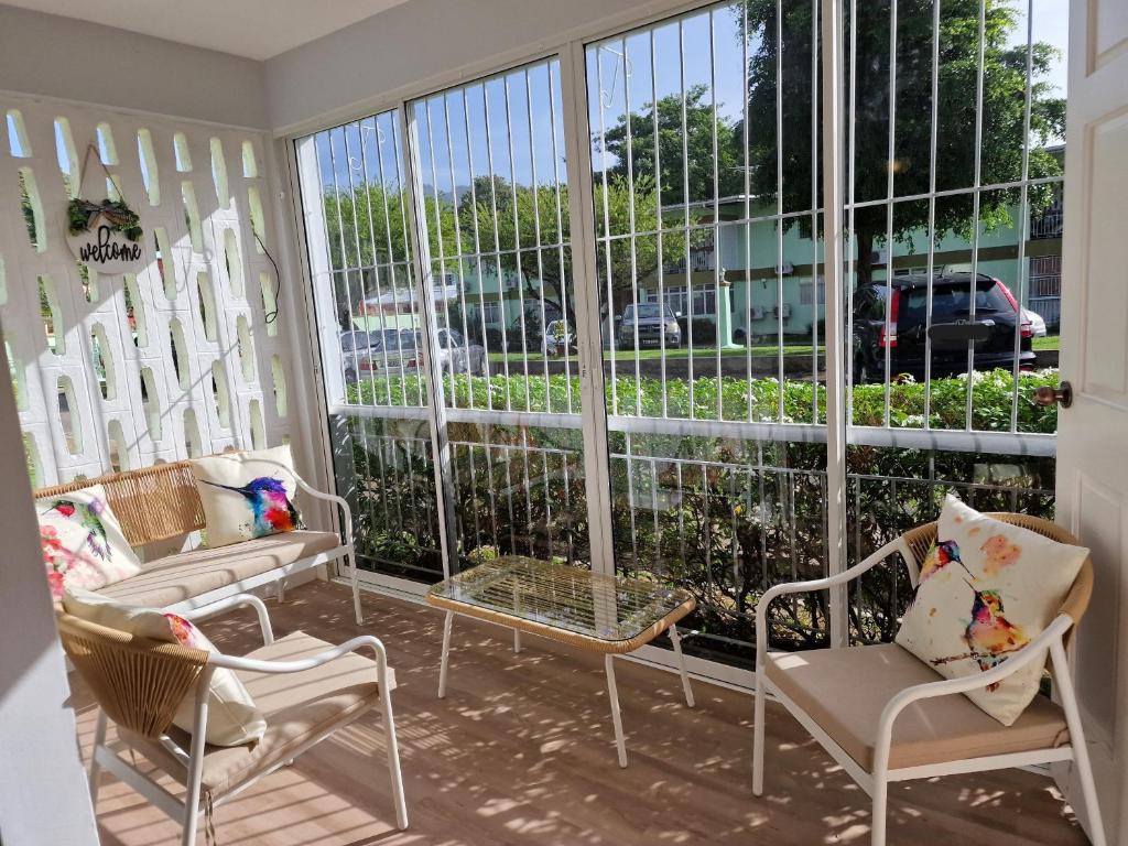 a screened in porch with chairs and windows at 2 Bed, parking, gated, modern in Saint Augustine