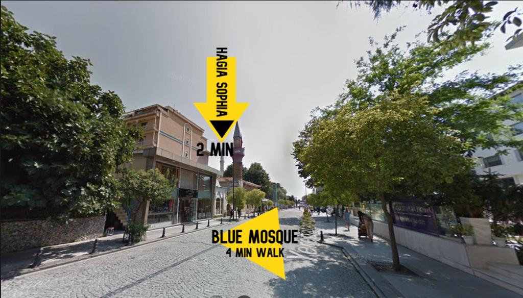 a yellow sign on a street with a blue noise and my walk sign at The Han in Istanbul
