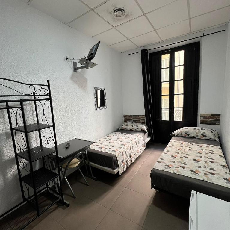 Postel nebo postele na pokoji v ubytování Hostal Milan