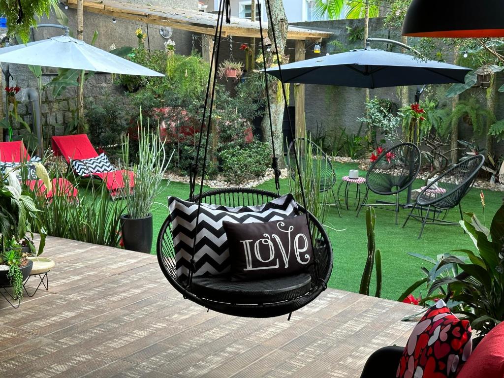 a swing with the words love hanging from a table at UFSC Guest House in Florianópolis