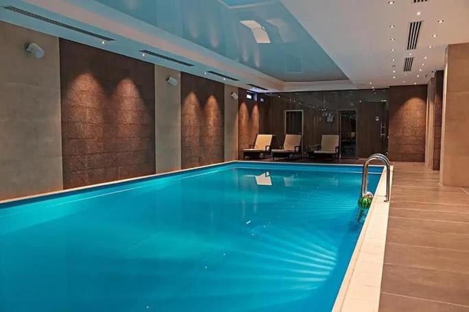 a large swimming pool in a hotel room at Orbi Palace Hotel Bakuriani in Bakuriani