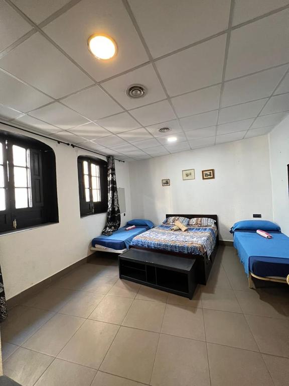 Postel nebo postele na pokoji v ubytování Hostal Milan