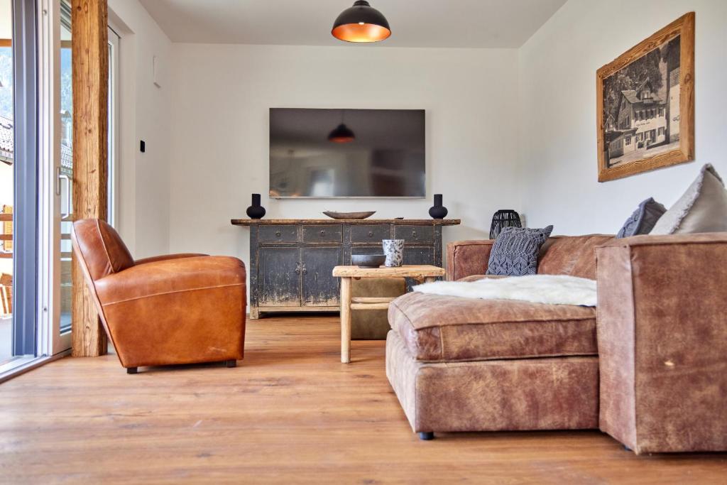 a living room with a couch and a chair at Sunshine Apartment Wood'n Rustic in Garmisch-Partenkirchen