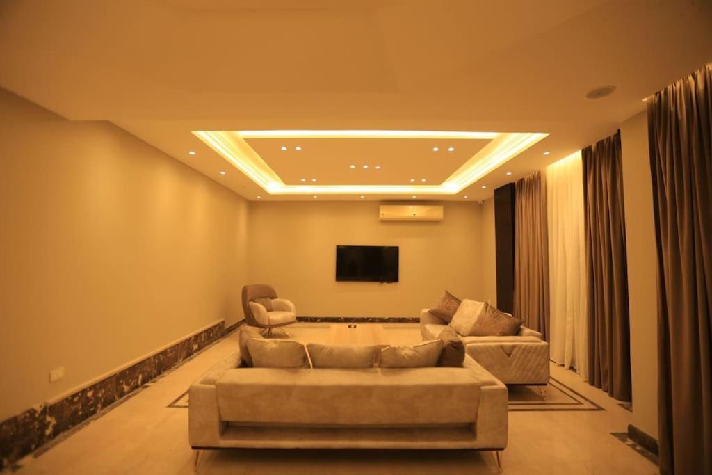 a living room with a couch and a flat screen tv at Munir`s residence 2 in Cairo