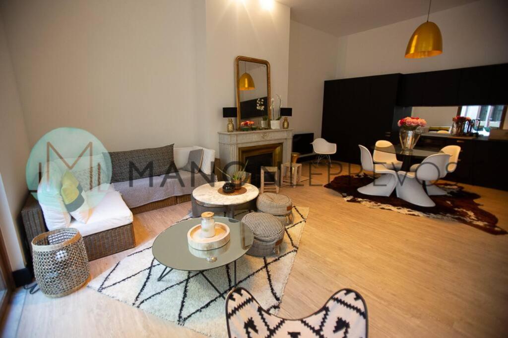 a living room filled with furniture and a fireplace at Extérieur Chartrons Jardin Public Quais Quinconces XAVIER ARNOZAN in Bordeaux