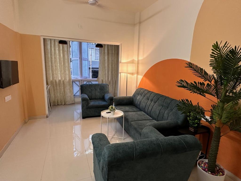 a living room with a couch and two chairs at Autumn: 1Bhk with Bathtub at Koregaon Park in Pune