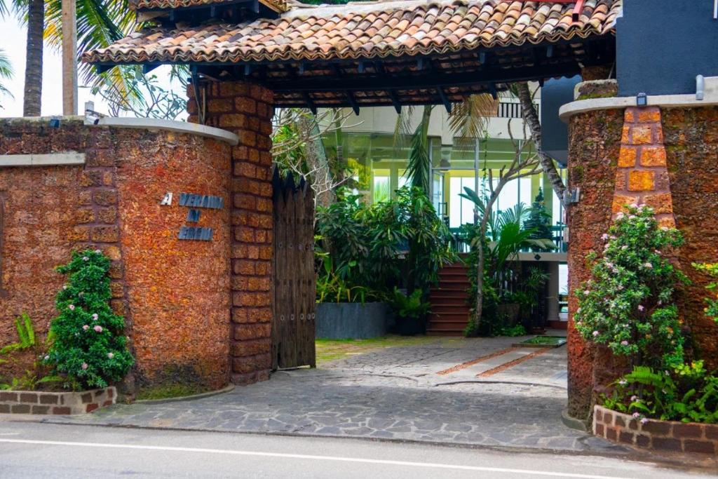 an entrance to a building with a brick wall at La Veranda Di Serena in Unawatuna