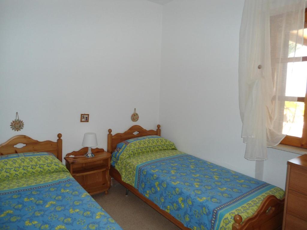 a bedroom with two beds and a window at Ville Alba & Azzurra in Polignano a Mare
