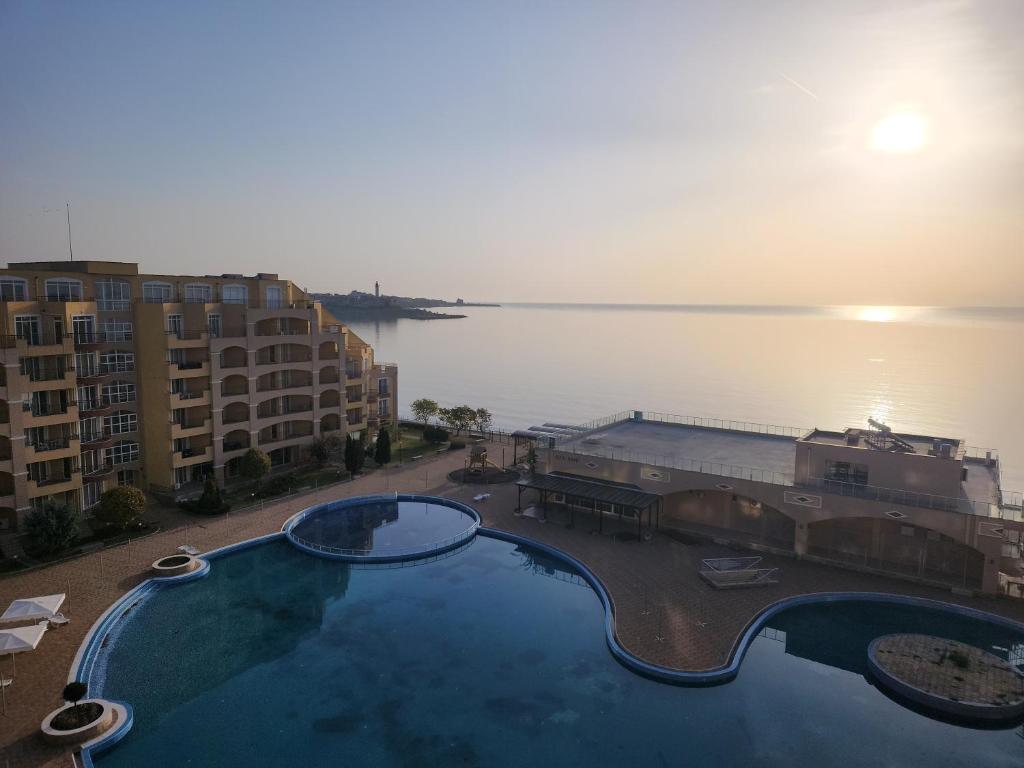 a swimming pool with a view of the water at Grand Midia Resort, Sky level apartments in Aheloy