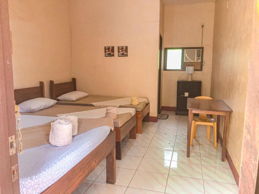 Postel nebo postele na pokoji v ubytování JBR Tourist Inn - Port Barton