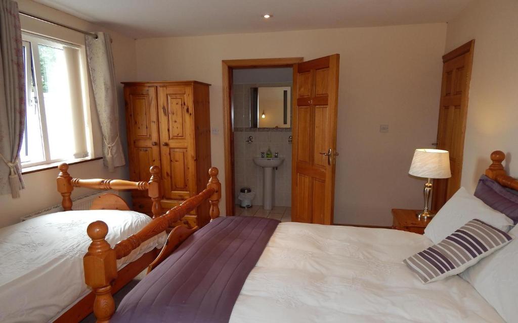 a bedroom with two beds and a bathroom at Glencove in Ennis