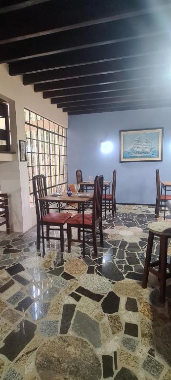 a dining room with a table and chairs at Canto Santo in Itapoa
