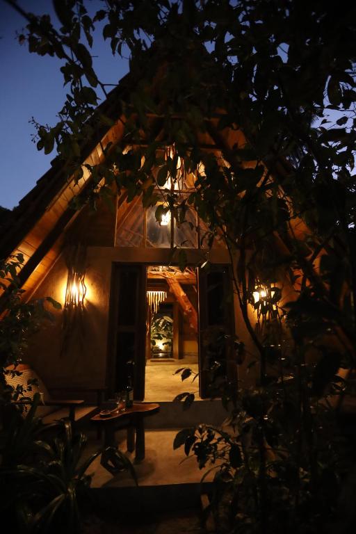 an entrance to a house at night with a table at Cinnamon Paradise Nature Room in Ahangama