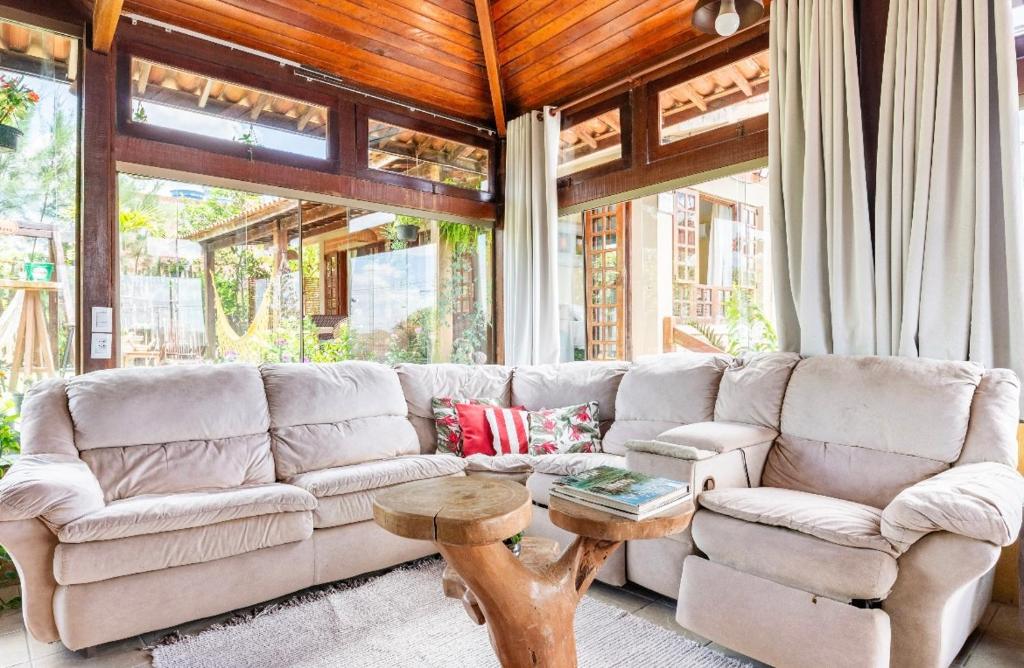 a living room with a couch and a table at Casa Santa Felicidade - Gravatá in Gravatá