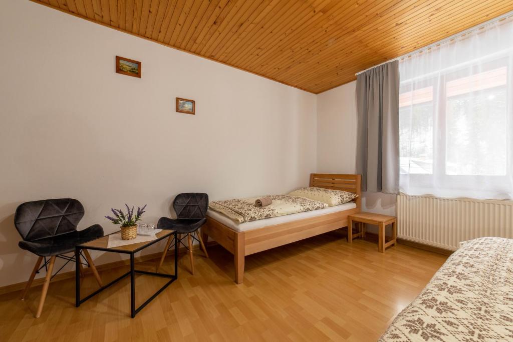 Postel nebo postele na pokoji v ubytování Penzión pod Kýčerou