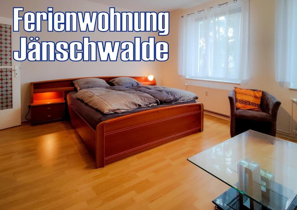 a bedroom with a bed and a glass table at Ferienwohnung Jänschwalde in Jänschwalde Ost