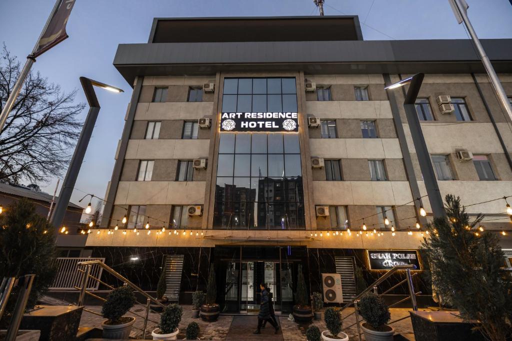 a man walks in front of a hotel at ART RESIDENCE Hotel in Tashkent