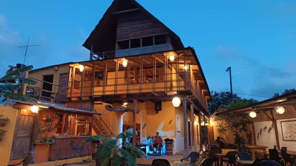 a building with a balcony with lights on it at La Posada del Gecko in Capurganá