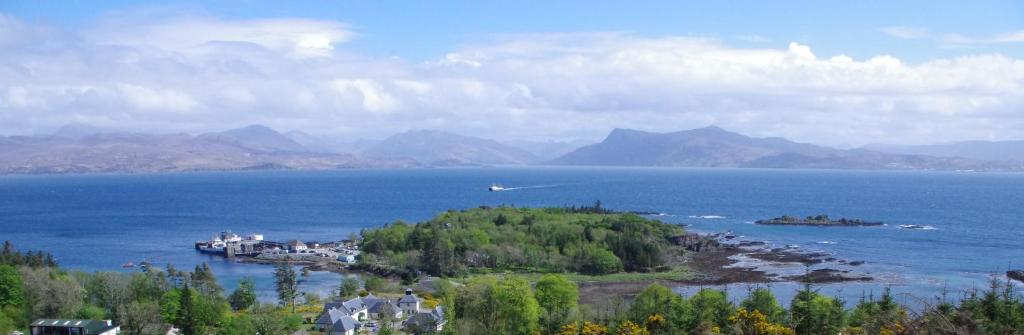 an island in the middle of a large body of water at Rubha Phoil in Ardvasar