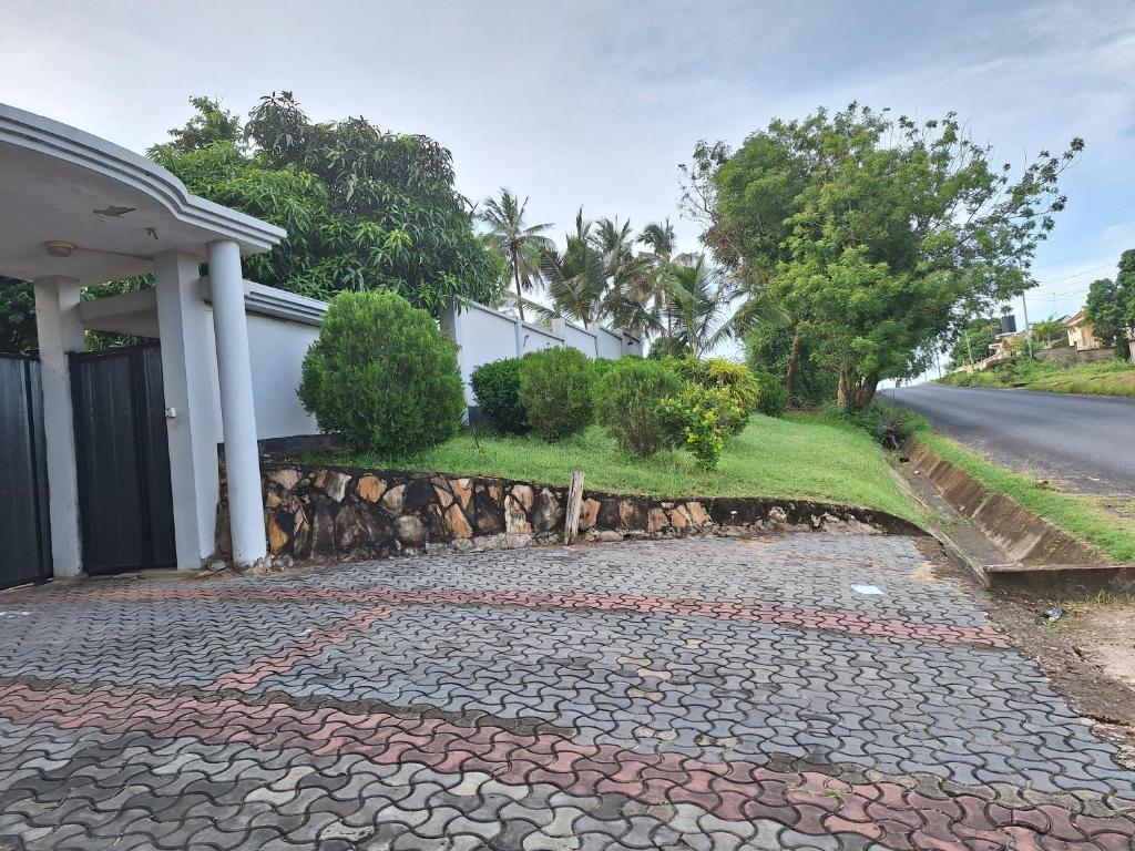 a cobblestone driveway in front of a house at One bedroom serviced apartment in Dar essalaam in Dar es Salaam