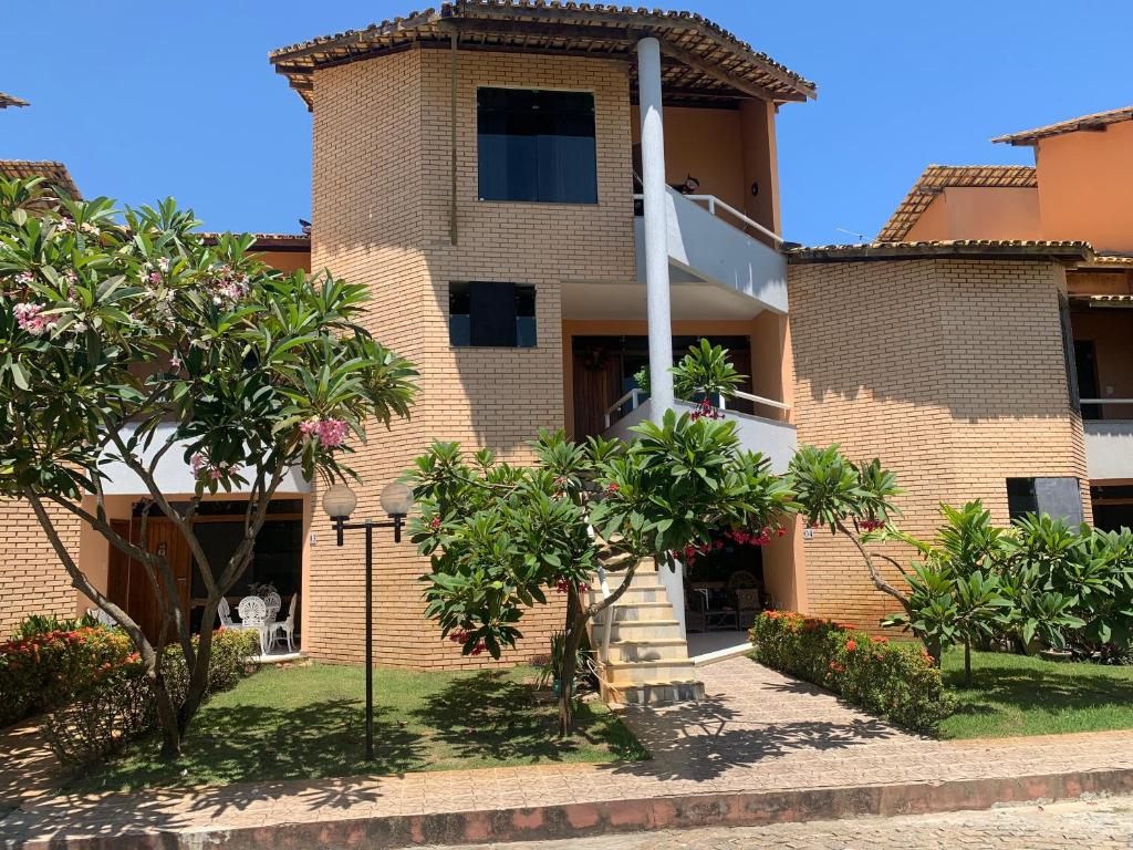 a building with trees in front of it at Casa vista mar in Aracaju