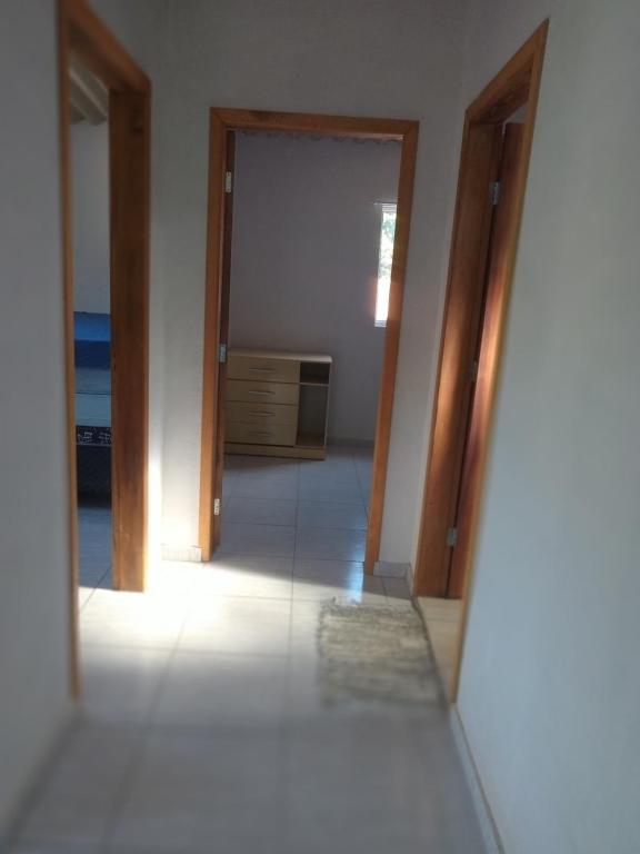 an empty room with two doors and a mirror at Meu cantinho in Ubatuba