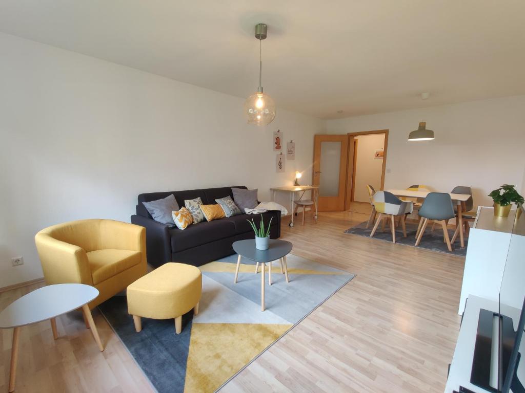 a living room with a couch and a table at 81qm, 3 bedroom, King-Bed, parking, fast Wifi, Netflix in Waiblingen