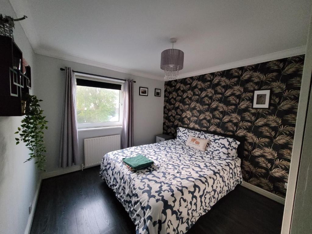 a small bedroom with a bed and a window at Cozy room London in Enfield