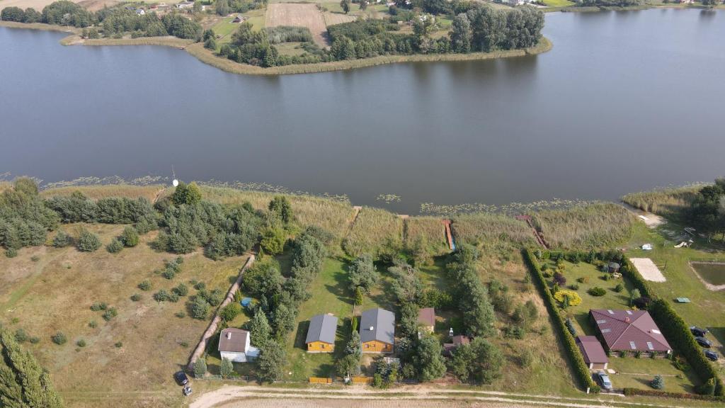 an aerial view of a farm and a lake at Kamieńczyk domek nad jeziorem z dostępem do pomostu in Kamieńczyk Dezerta