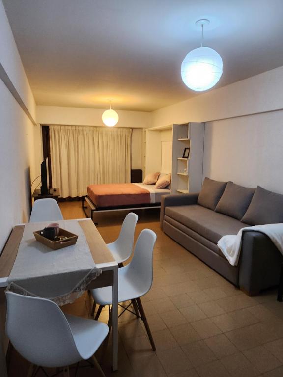 a living room with a couch and a bed at LUAMAR 2-SAINT MICHELE in Mar del Plata