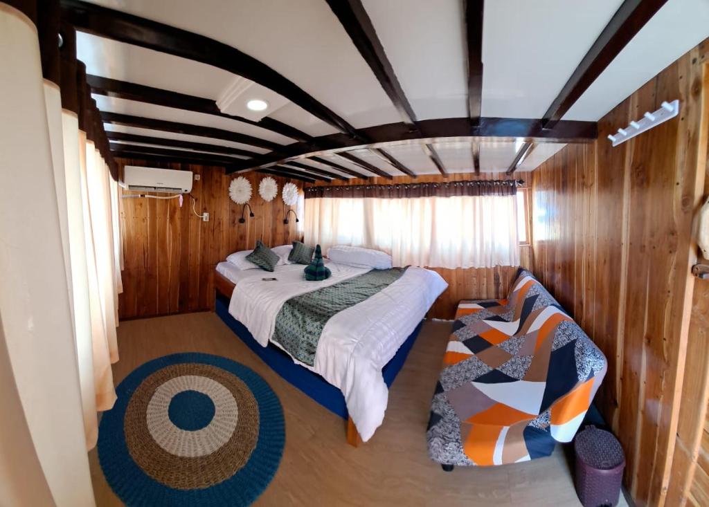 a bedroom with two beds in a boat at Tour komodo in Labuan Bajo