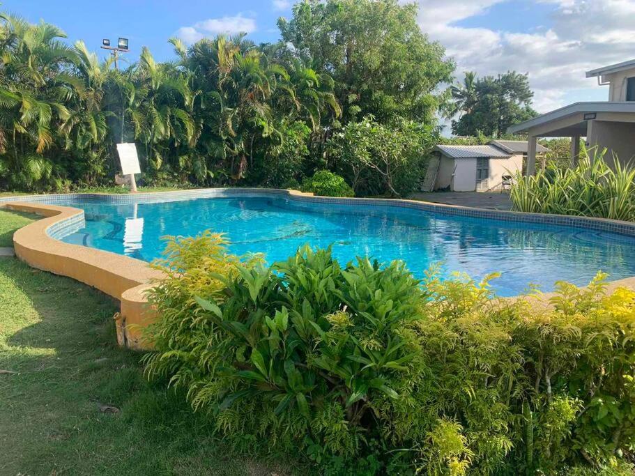 a large blue swimming pool in a yard at Ambitious Apartment Lot 7 in Nadi