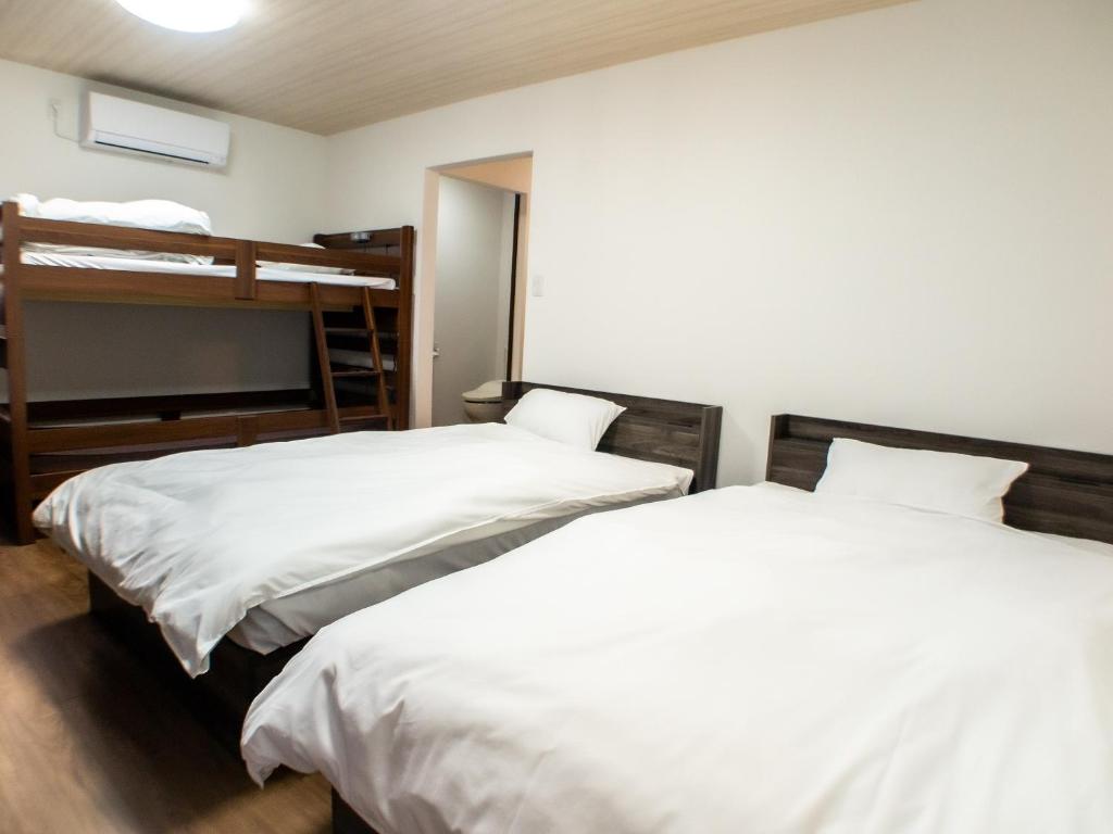 Postel nebo postele na pokoji v ubytování Shima no Hotel