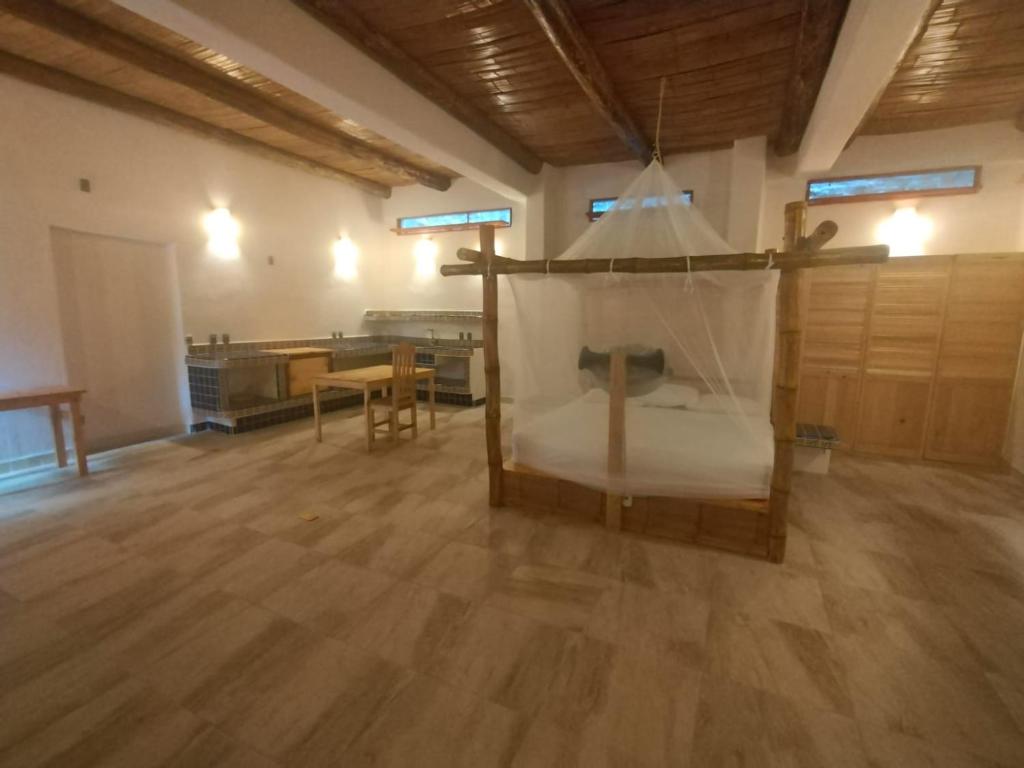 Cette chambre comprend un lit et une table. dans l'établissement Bambú Ecocabañas, à San Agustinillo