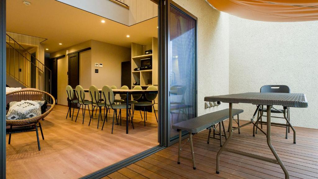 a dining room with a table and chairs at Rakuten STAY VILLA Kamogawa in Kamogawa