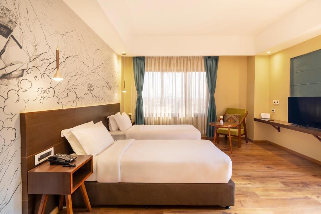 TV a/nebo společenská místnost v ubytování Atisha Hotel