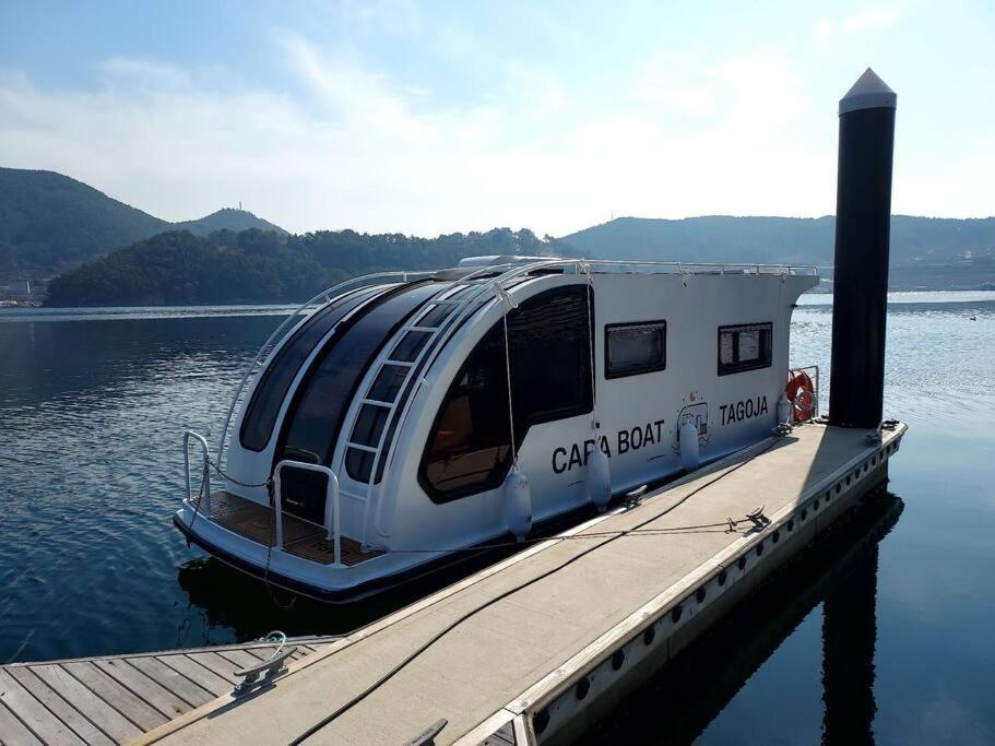 a boat is docked at a dock on the water at Tagoja Caravanboat Stay in Tongyeong