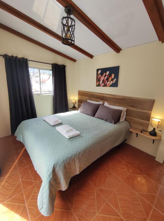 a bedroom with a large bed in a room at Rooftop "Montalvo" in Baños