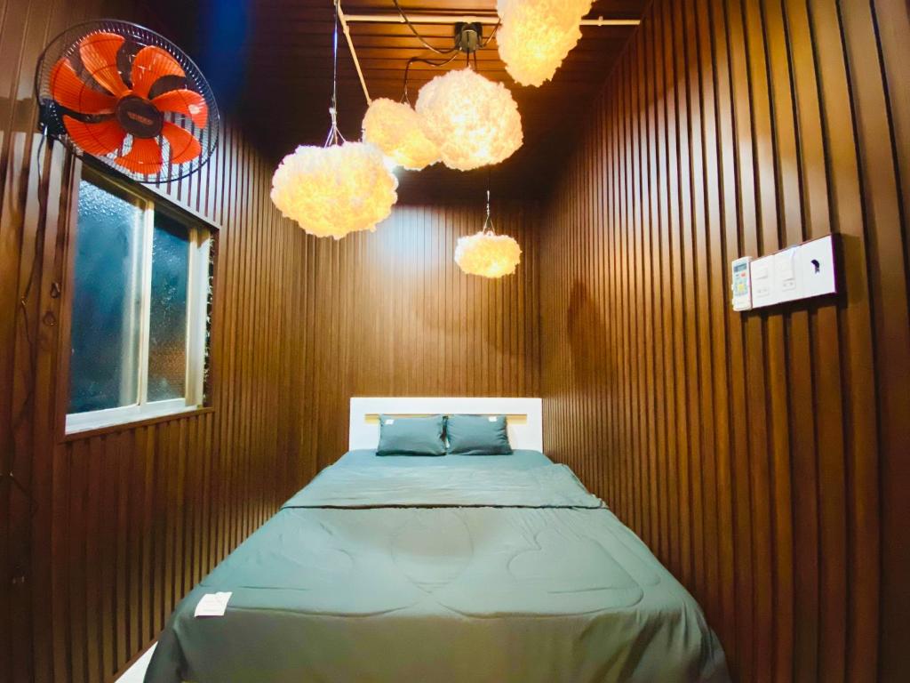 a bedroom with a bed in a wooden wall at SKY Homestay in Ấp Ðại Tài (2)