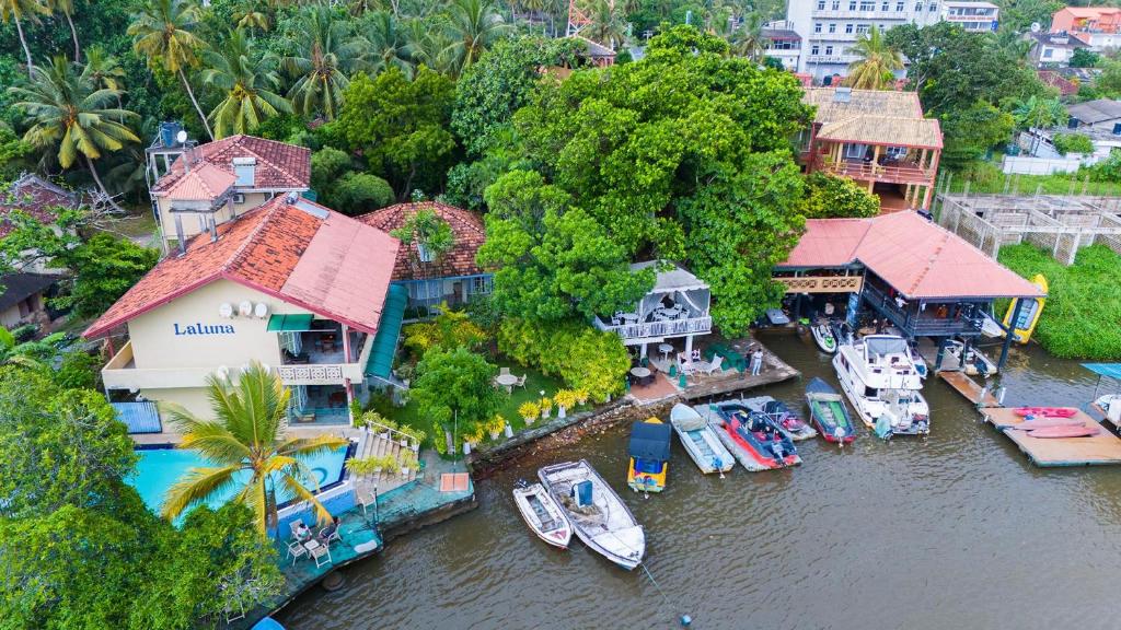 an aerial view of a house with boats in the water at Laluna Ayurveda Resort in Bentota