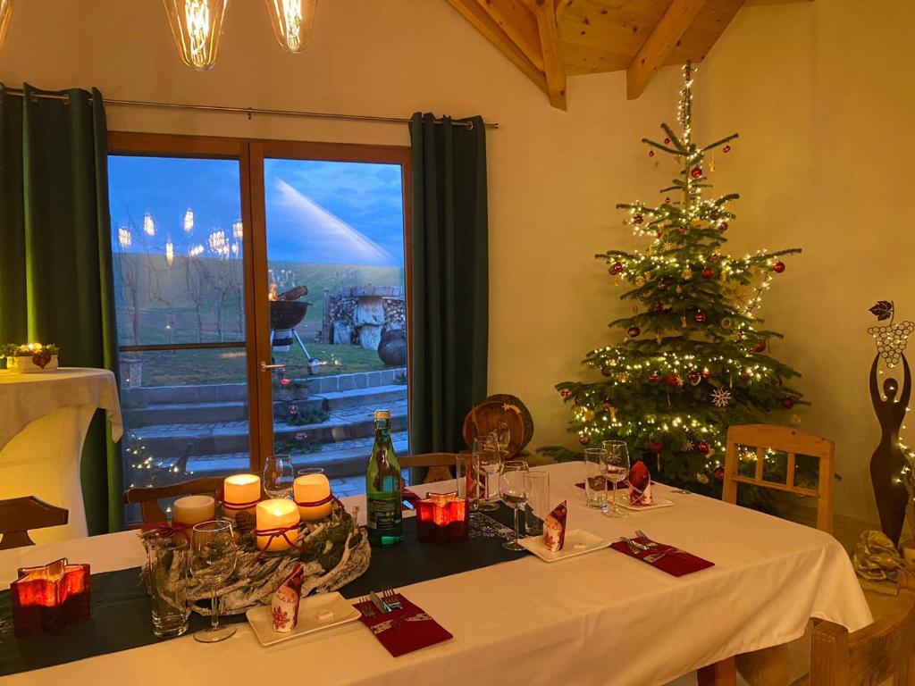 a table with a christmas tree in a room at Franzls Kellerschlössel 