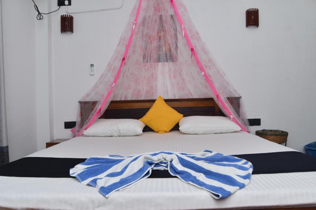 een slaapkamer met een bed en een tent bij Kosi Giggles Resort in Weligama