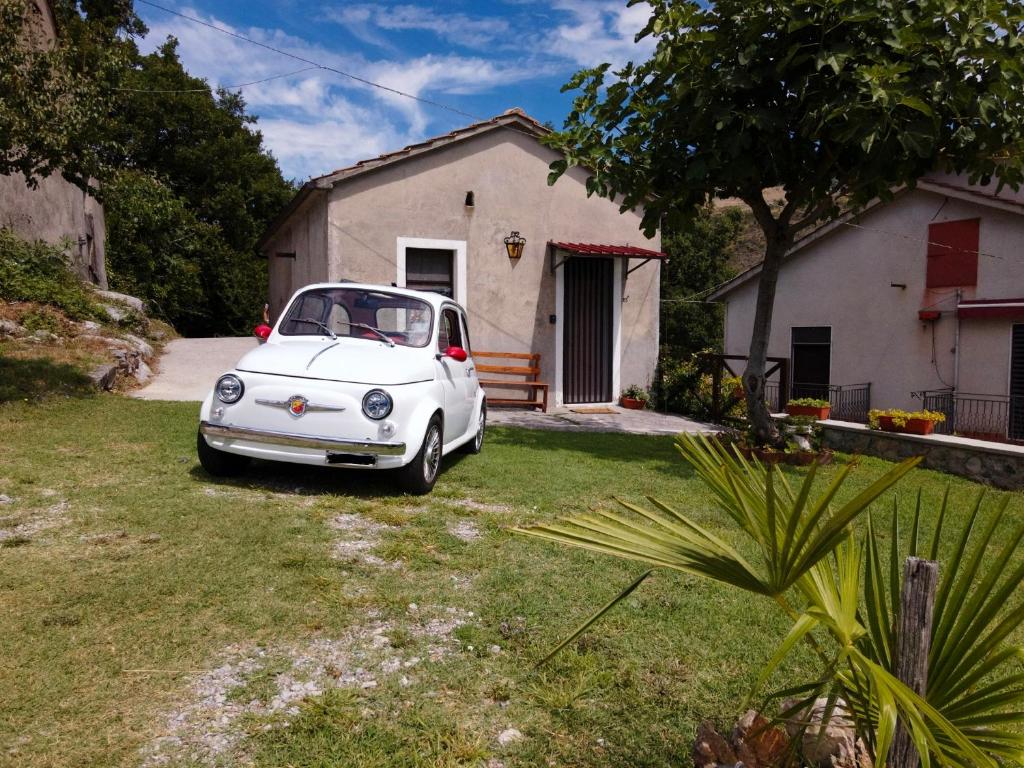 a white car parked in front of a house at Lime House in Lauria