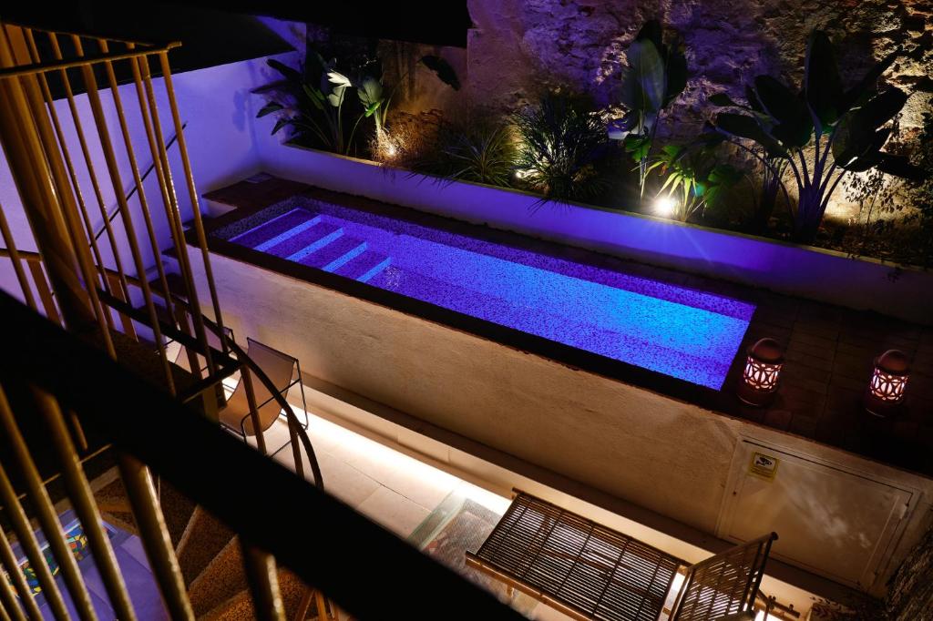 an overhead view of a swimming pool at night at Dormsy aparthotel House in Arenys de Mar