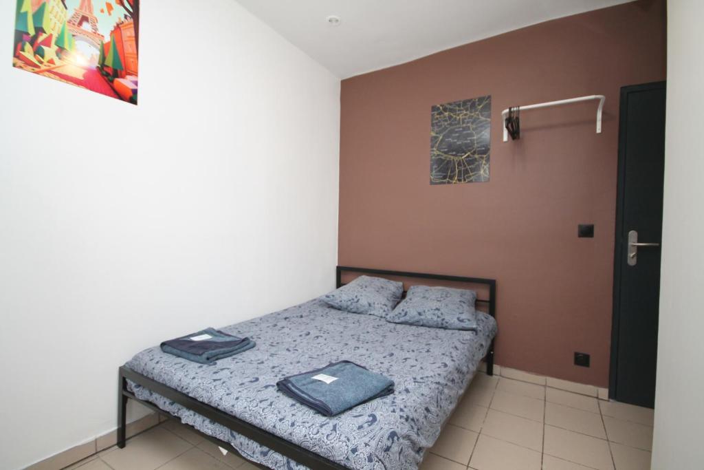 a small bedroom with a bed with blue sheets at 08 - Chambre proche Paris et Transports avec TV WIFI in Saint-Denis